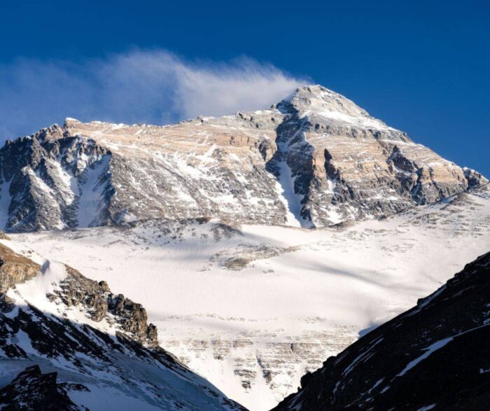 Everest looking pretty dry and with a wind plume rising from the summit ridge.
