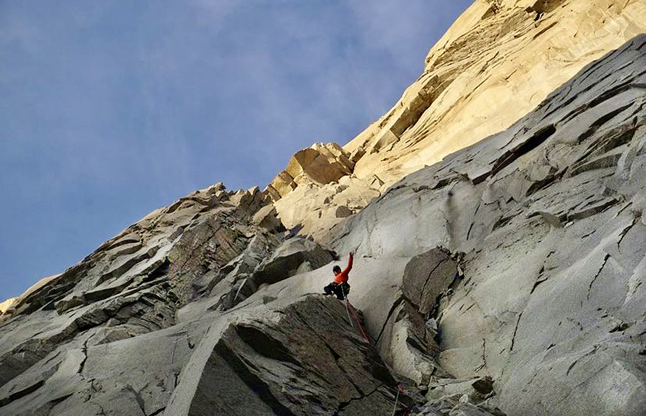 a climber in the shadows moves toward sunlight