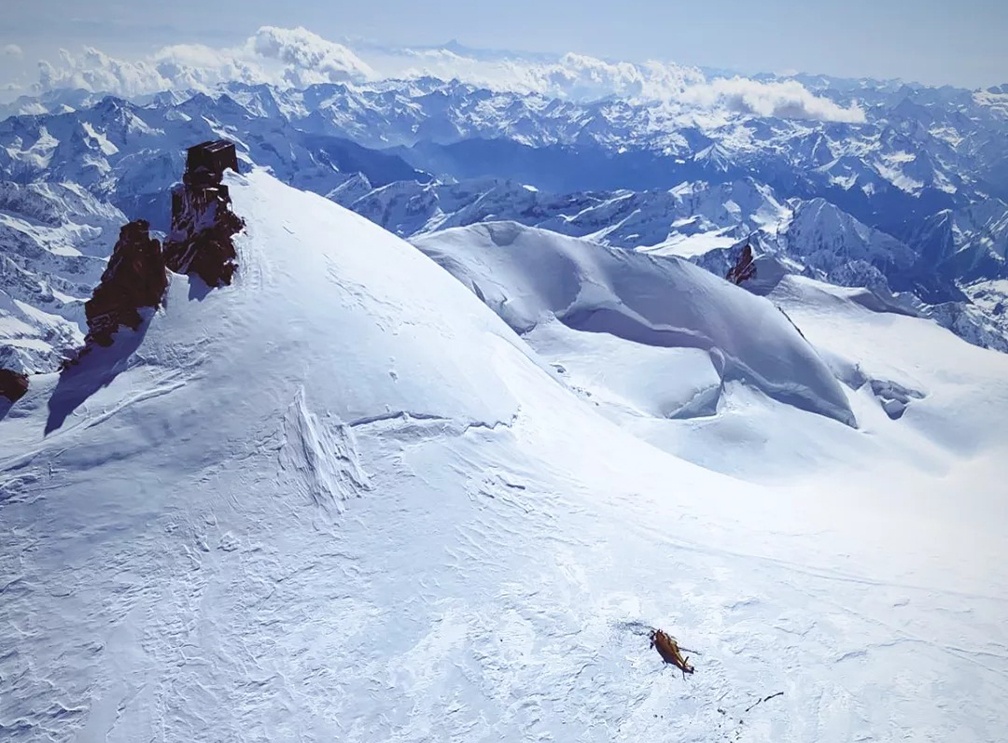 the helicoper laying on a huge glacier on Monte Rosa's summit area.