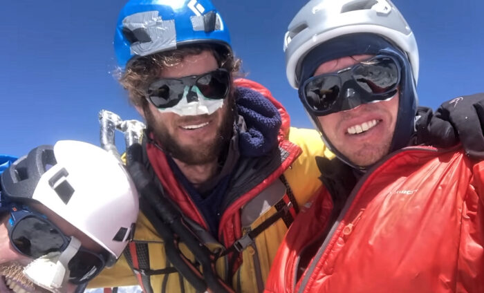 three smiling mountaineers