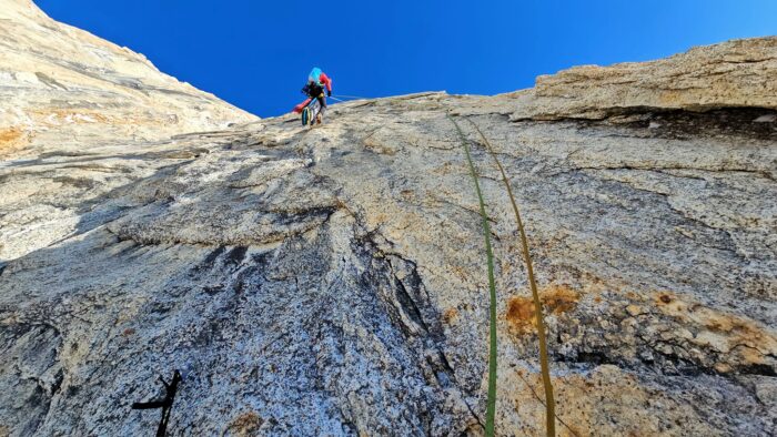 The climber as seen from below up a rock face.