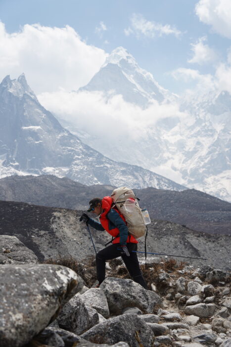 The runner with poles, a backpack and mountain clothes.