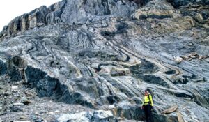 woman standing in front of swirled rock formation