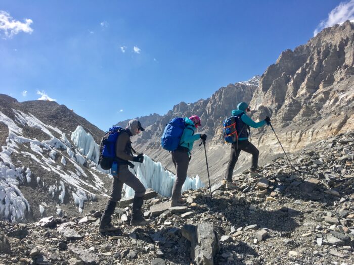 Clombers on glacial terrain, with morraine rocks and some penitentes. 