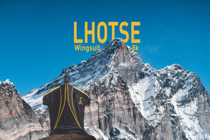Expedition banner featuring Howell in wingsuit and Lhotse behind.