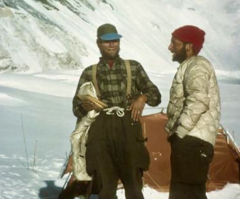 Two climbers in snow talking