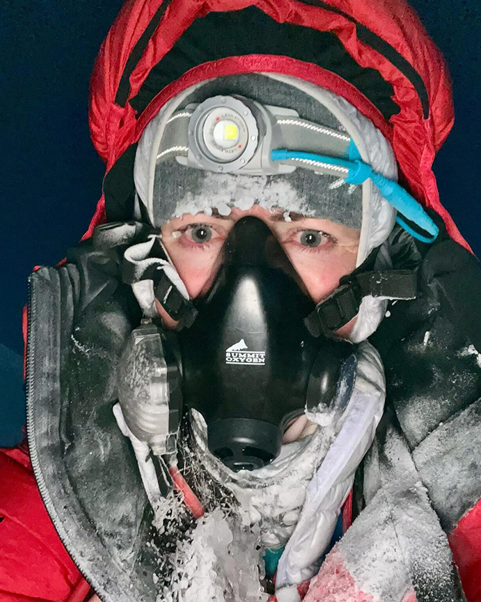 Kolouchova wearing O2 mask, a headlamp and high altitude clothes.