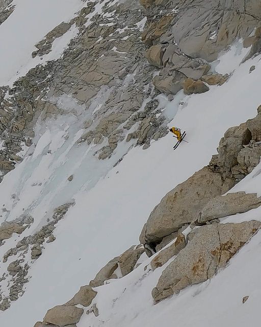 Ziemski skis down a snowy patch on an otherwise rocky, steep section of Makalu.