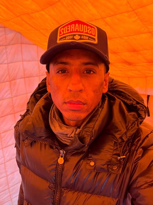 Rashid inside a yellow tent. 