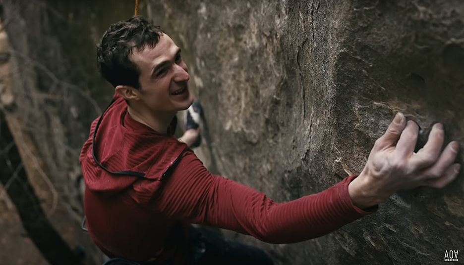 smiling climber closeup on rock face