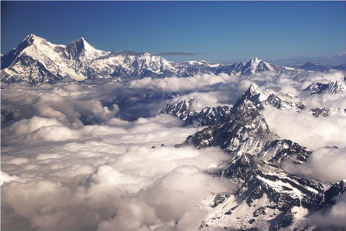 Shisha Pangma looking far away, with low clouds covering the Tibetan valleys.