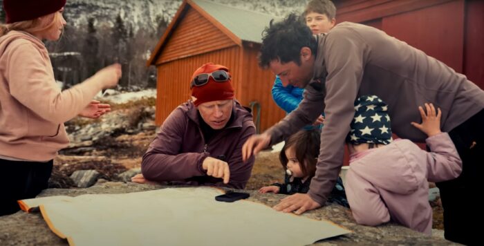 a group of people look at a map
