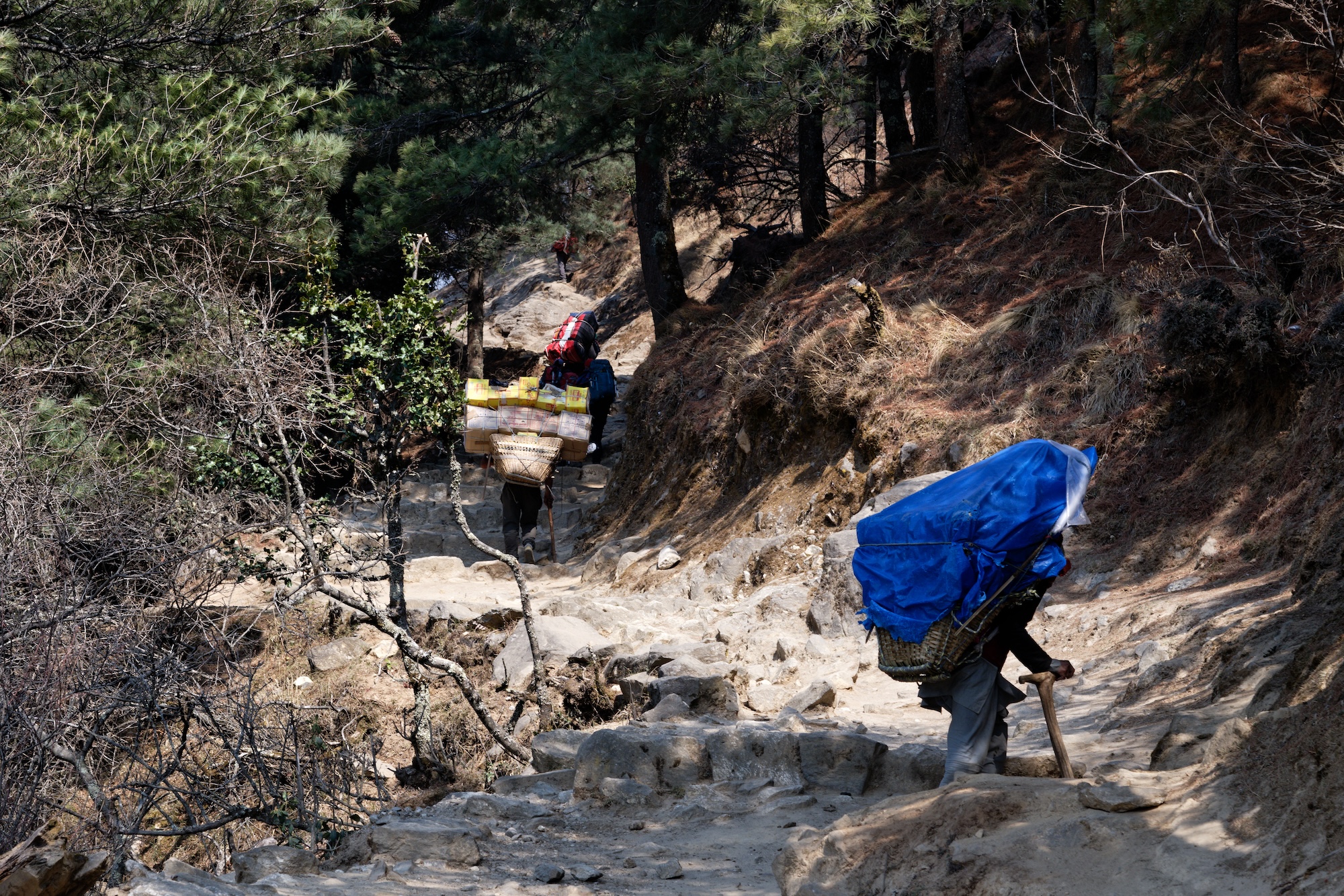 Local porters move loads toward Namche Bazar.