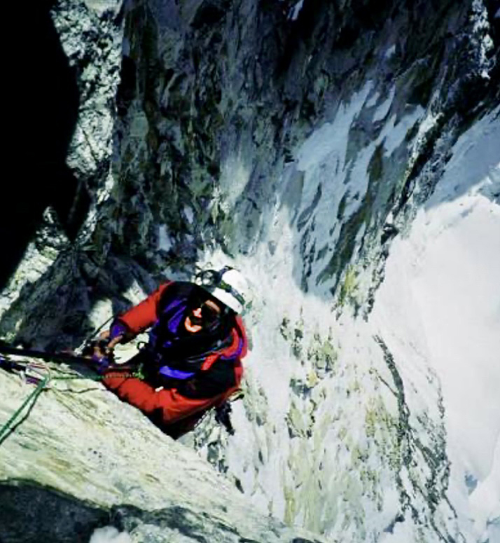 old photo of climber in red climbing