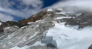 Makalu slopes, mainly on rock, a wind plume rising