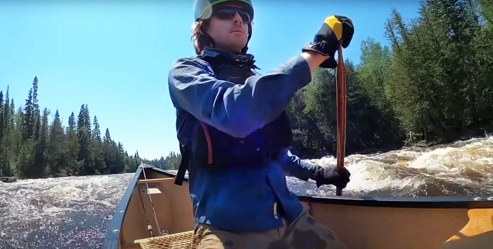man paddling canoe in rapids