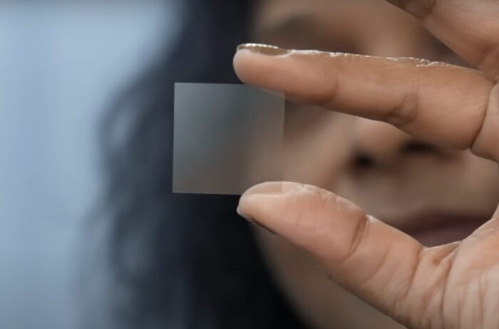 A clear glass-like tile about one inch square in size