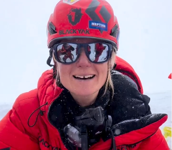Close shot of Uta Ibrahimi as she speaks on a video, with sun glasses and helmet