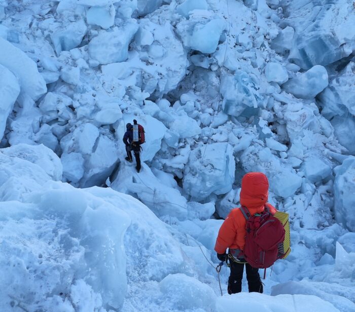 Climbers descending among a maze of ice blocks on Everest's Khumbu Icefall.