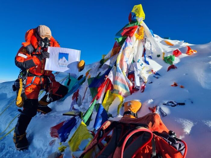 Climber with O2 mask on the summit of Everest