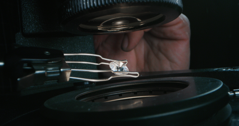 examining a diamond under a scope