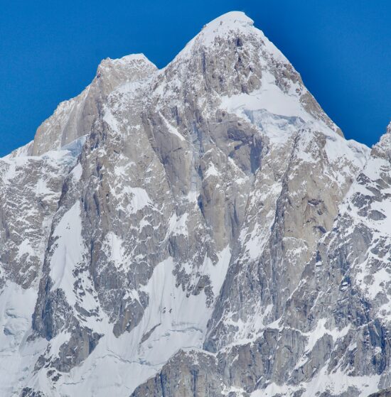 A pyramidal peak of rock and ice.