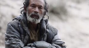 pakistani man with arms crossed in jacket