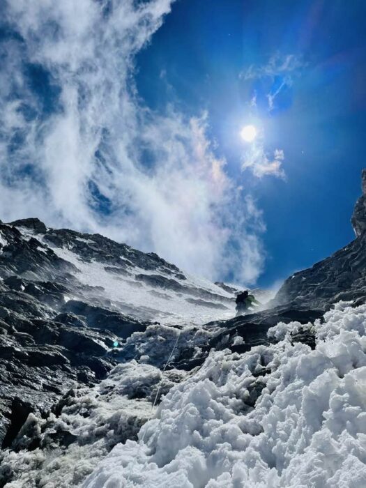 A climber up a mixed couloir, seen from below