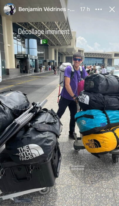 Climber with a heavily-loaded trolley at an airport