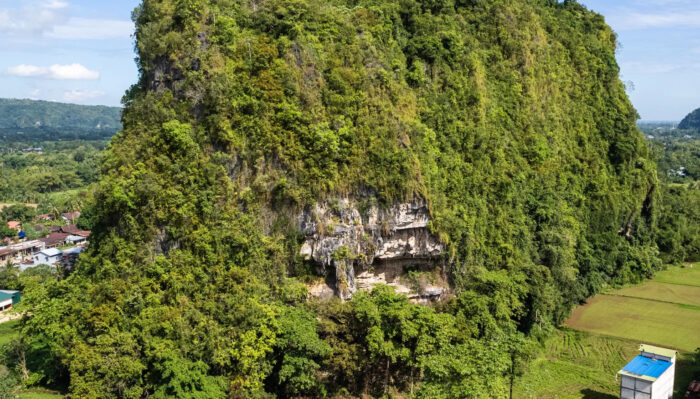 a photo of a cave on a steep mountain