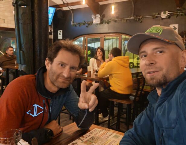 Climbers sitting at a restaurant table.
