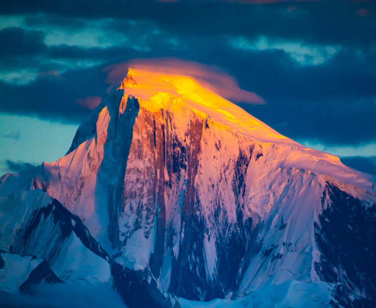Golden light on the summit of Spantik at sunset.