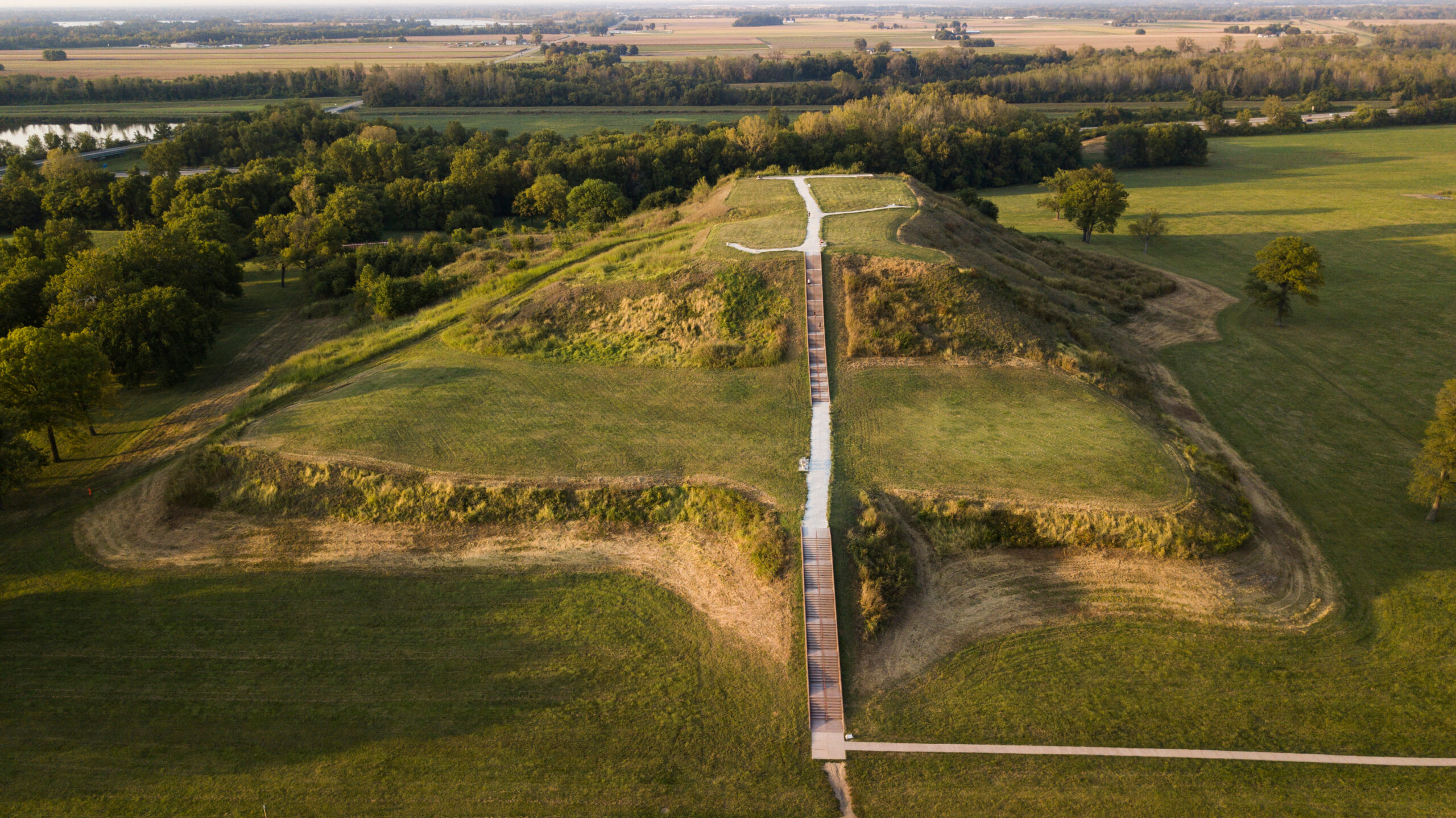 two-tiered grass mound with steps to the top