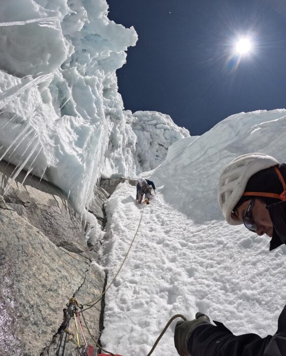 Climbers on ice funners and snow mushrooms and cornices