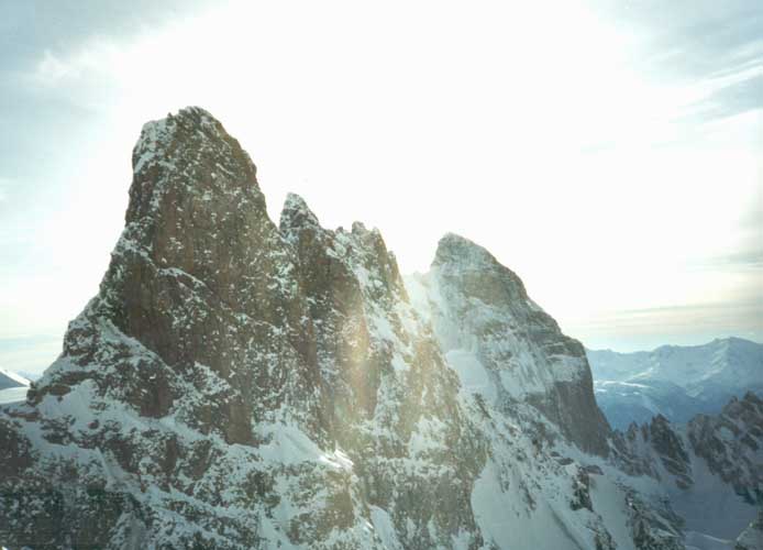 A sharp peak with several point, on rock and ice.