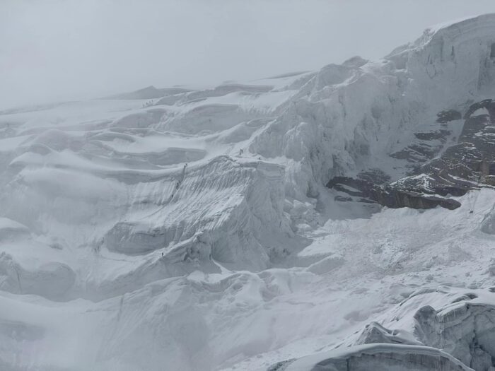 Climbers between Camp 1 and Camp 2 on Manaslu in foggy weather.