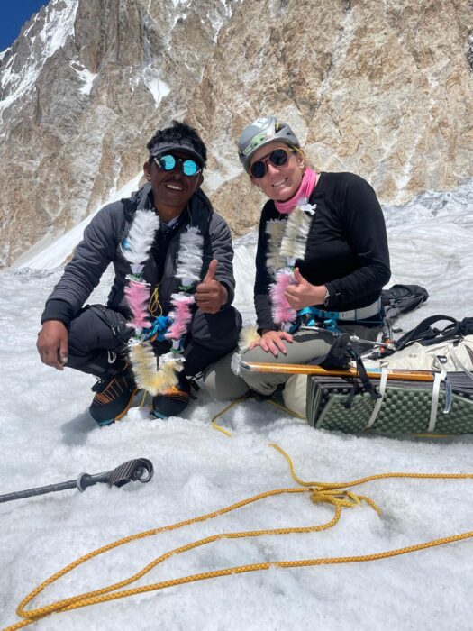 The climbers squatting on the snow