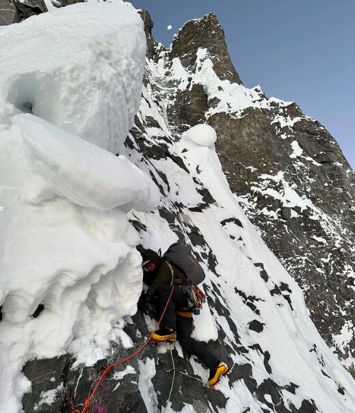 A clibmer on Mixed terrain, among snow mushrooms and iced up rock.