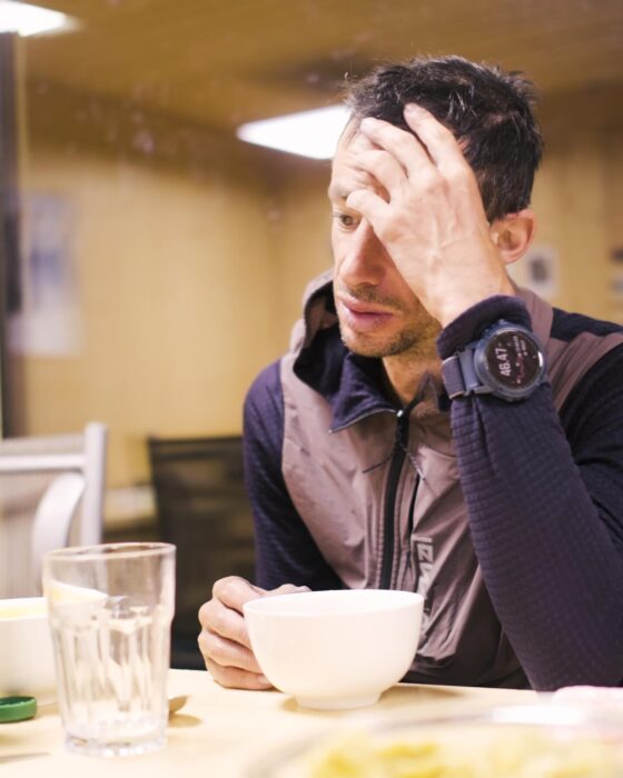 Jornet looks tired while having breakfast on a mountain hut.