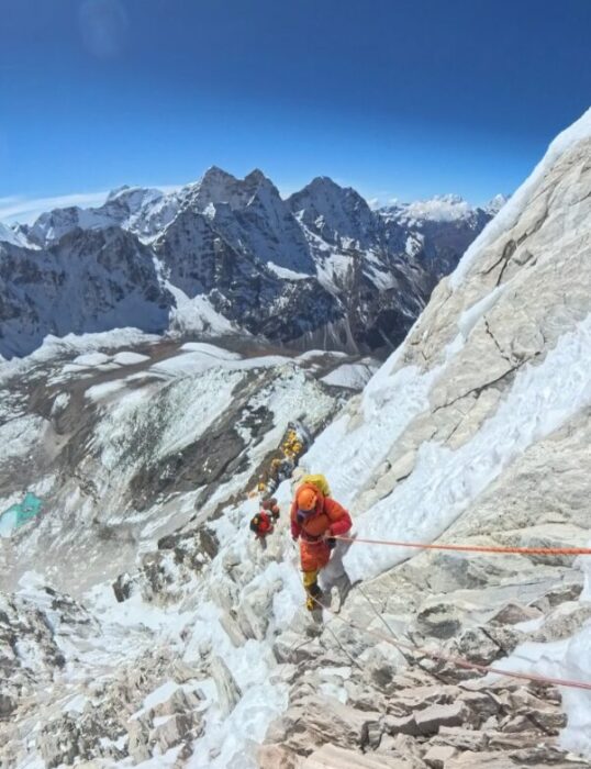 climbers on a mixed section at Ama Dablam, clipped to afixed rope.