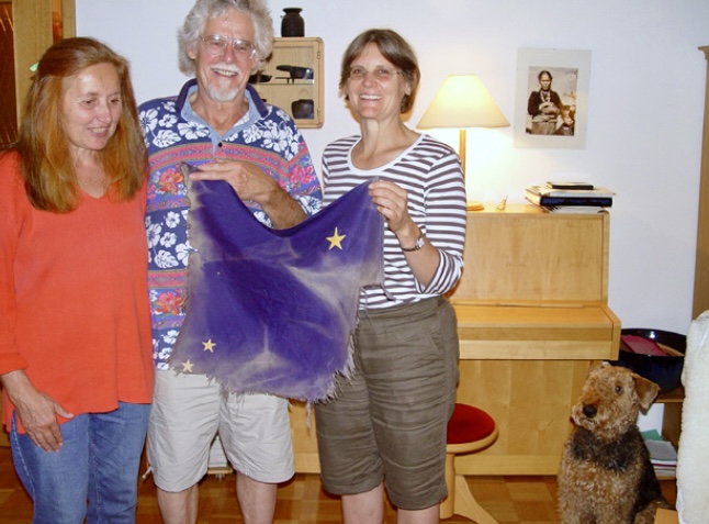Second-summiter Peter von Gizycki present Bill Long's 1966 summit flag to Pete Schoening's daughter Lisa in Germany, in 2007.