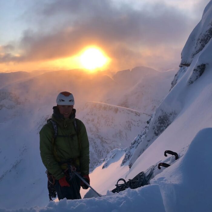 Juho Knuuttila at a belay under the northern sunset.