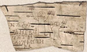 A child's drawing of two human figures beside text in Old Novgorod, written on birch bark.