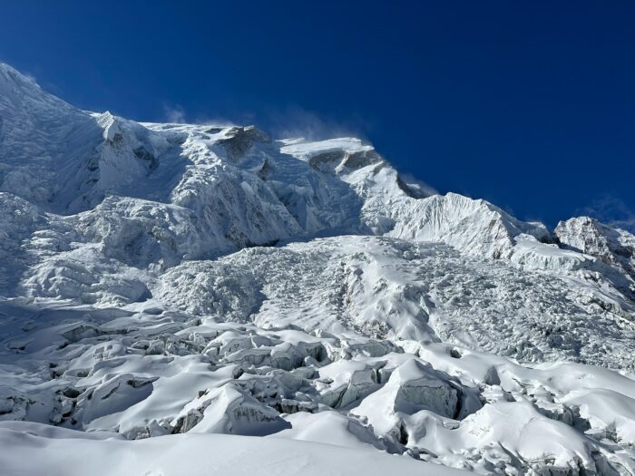 Annapurna loverloaded with snow and with a wind plume rising from the summit ridge.