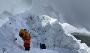 Sherpas rappeling from a snow anchor down an icefall on Annapurna