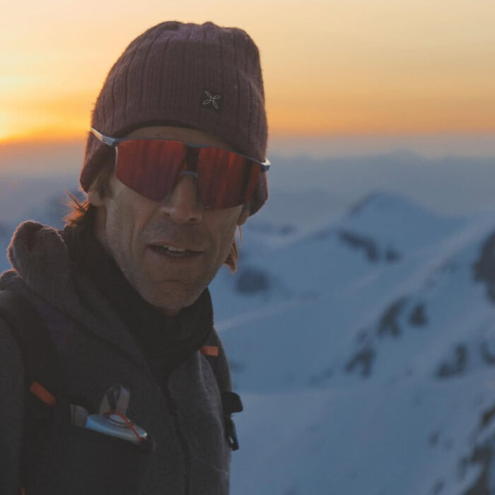 Herve Barmasse takes a selfie at sunset with the Appenine mountains behind him.