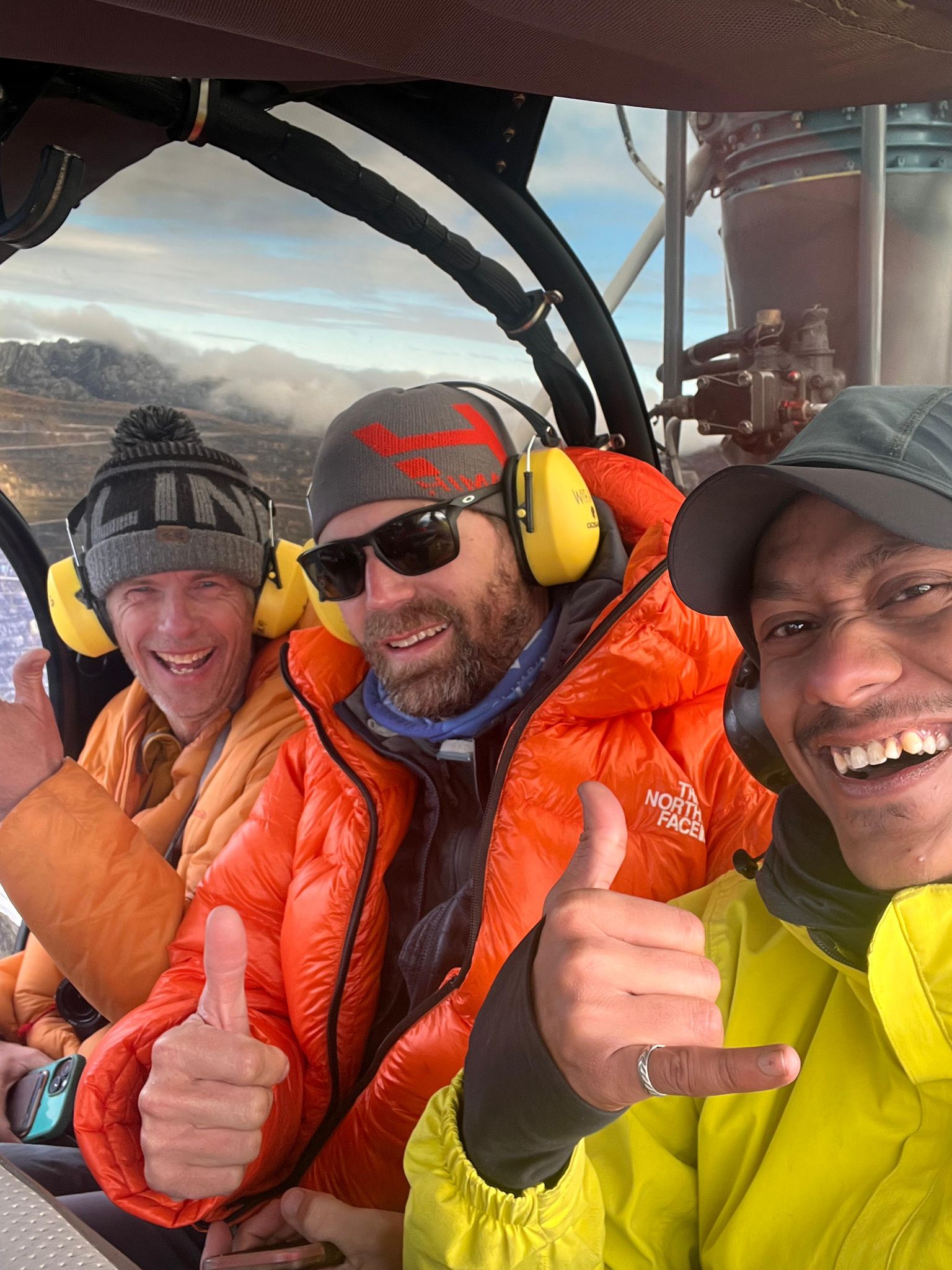 Mike Hamill with clients in a helicopter to Carstensz Pyramid BC