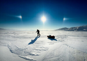backlit photo of sledder and sundog