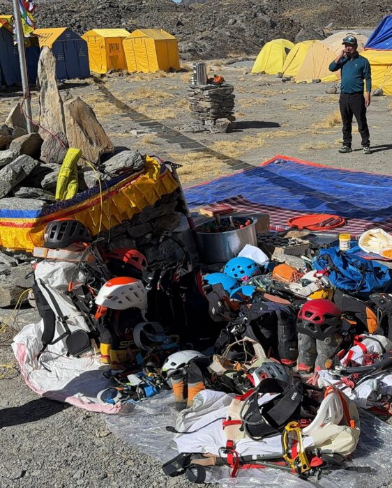 Mountain gear piled by a chorten for a presummit push puja on Annapurna