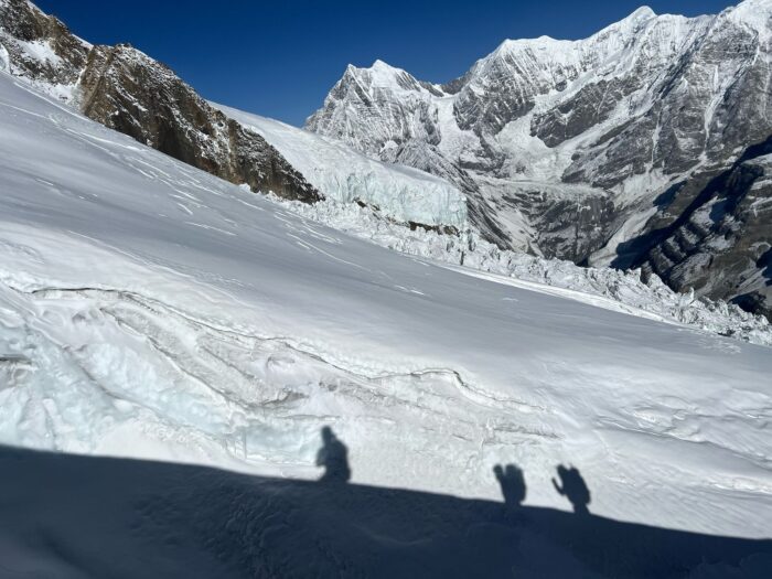 Shadow of climbers on Annapurna. 